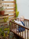 baby in crib in garden