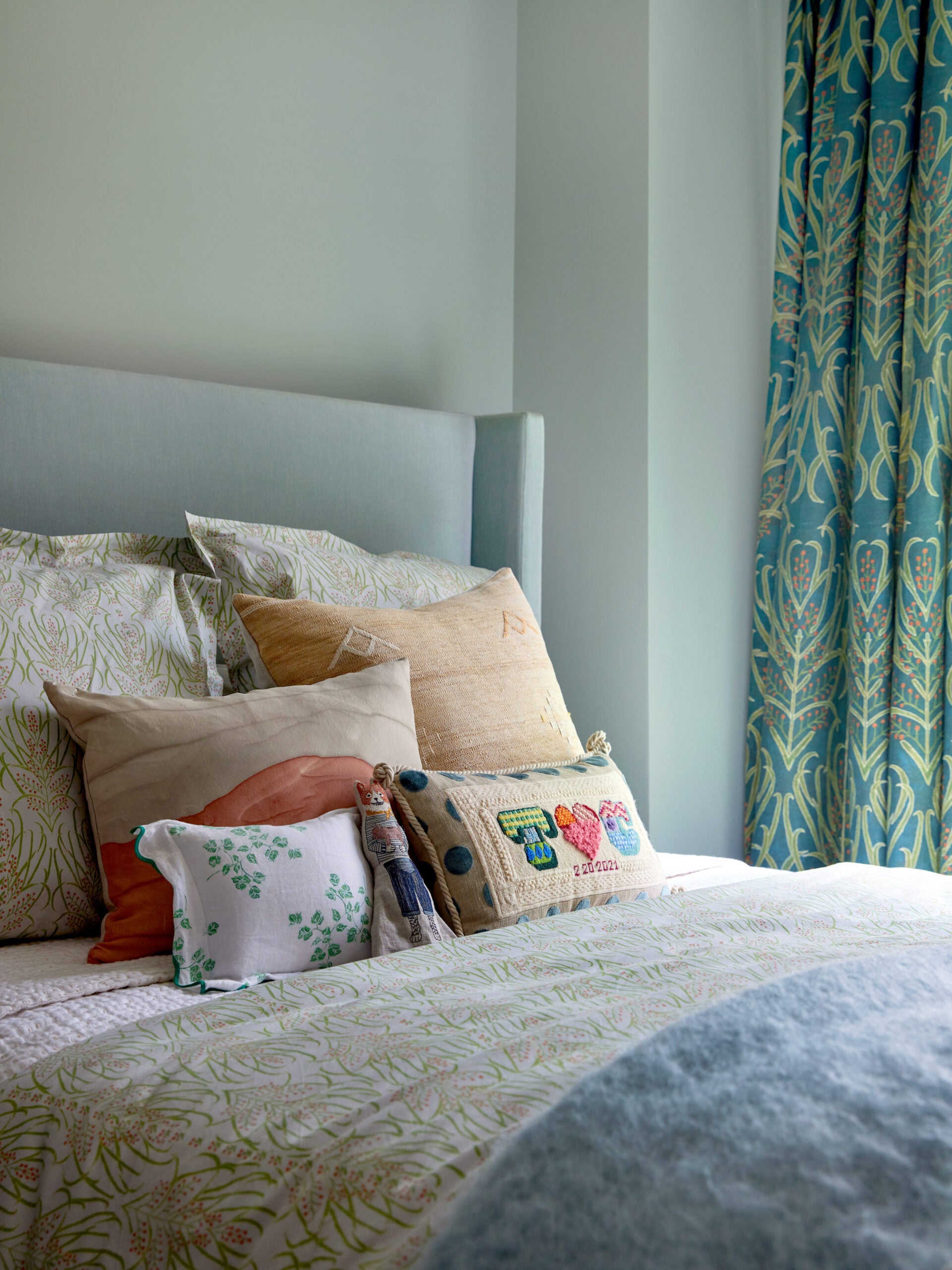 bed in nursery with pale green and blue color scheme