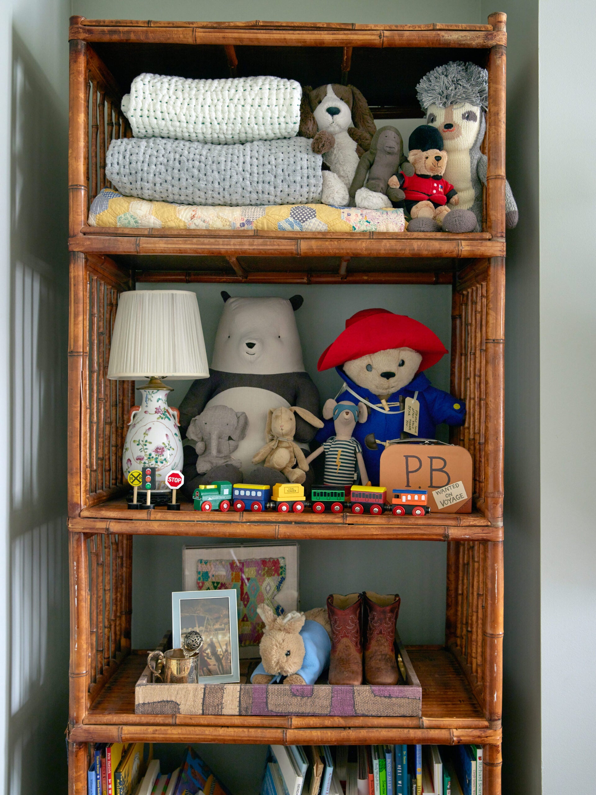 vintage wood bookcase filled with baby items