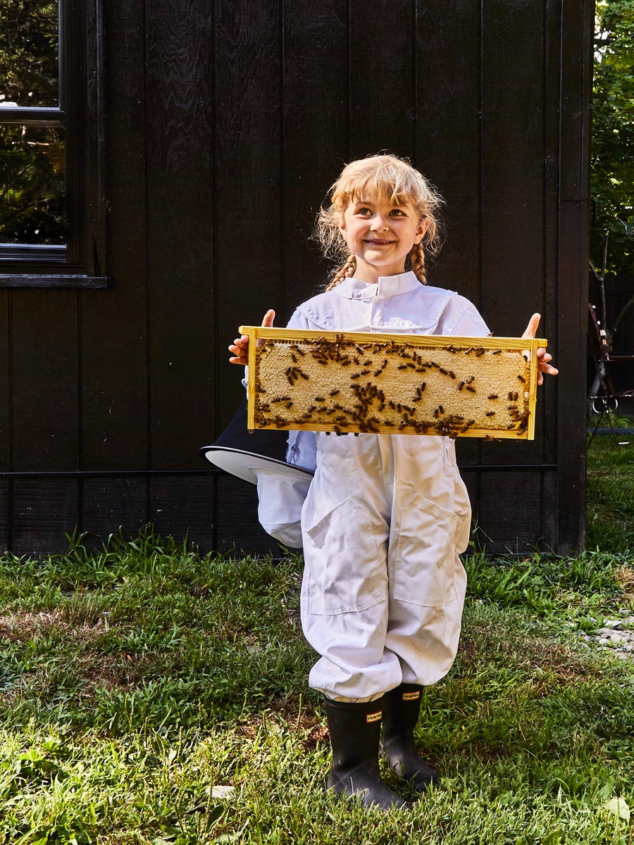 child holding bee honeycomb