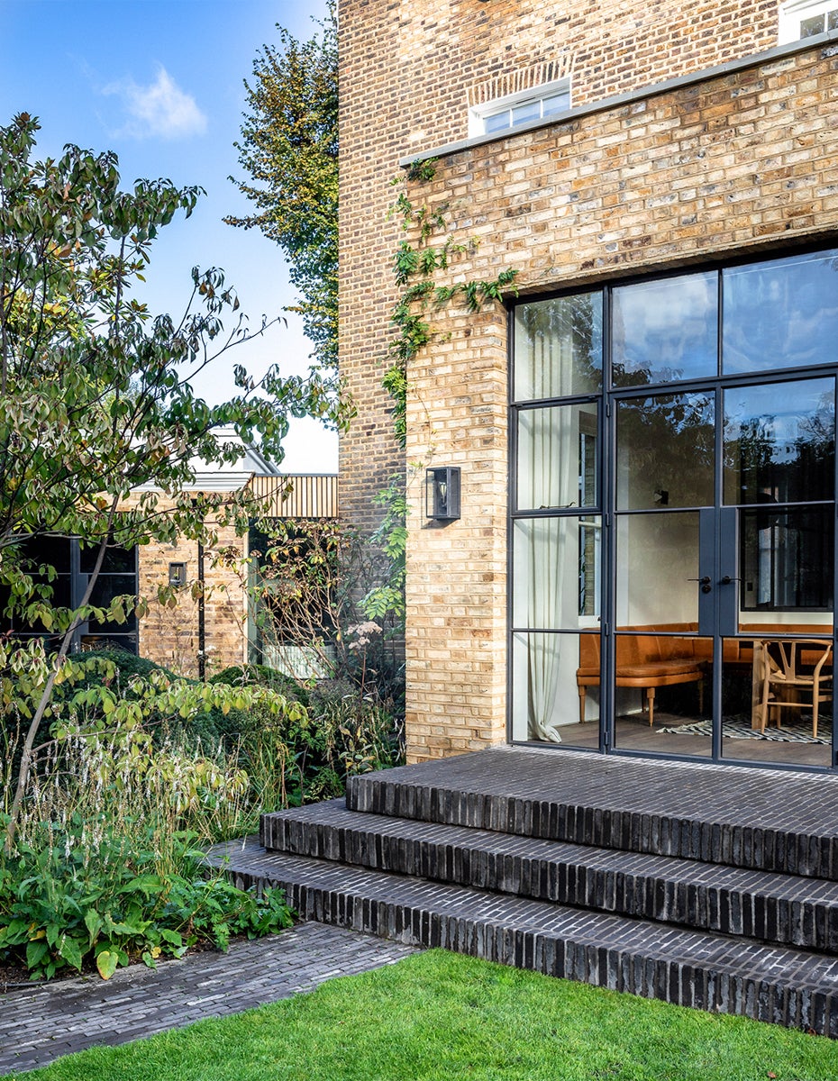 london brown brick house black brick patio pavers