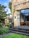 london brown brick house black brick patio pavers