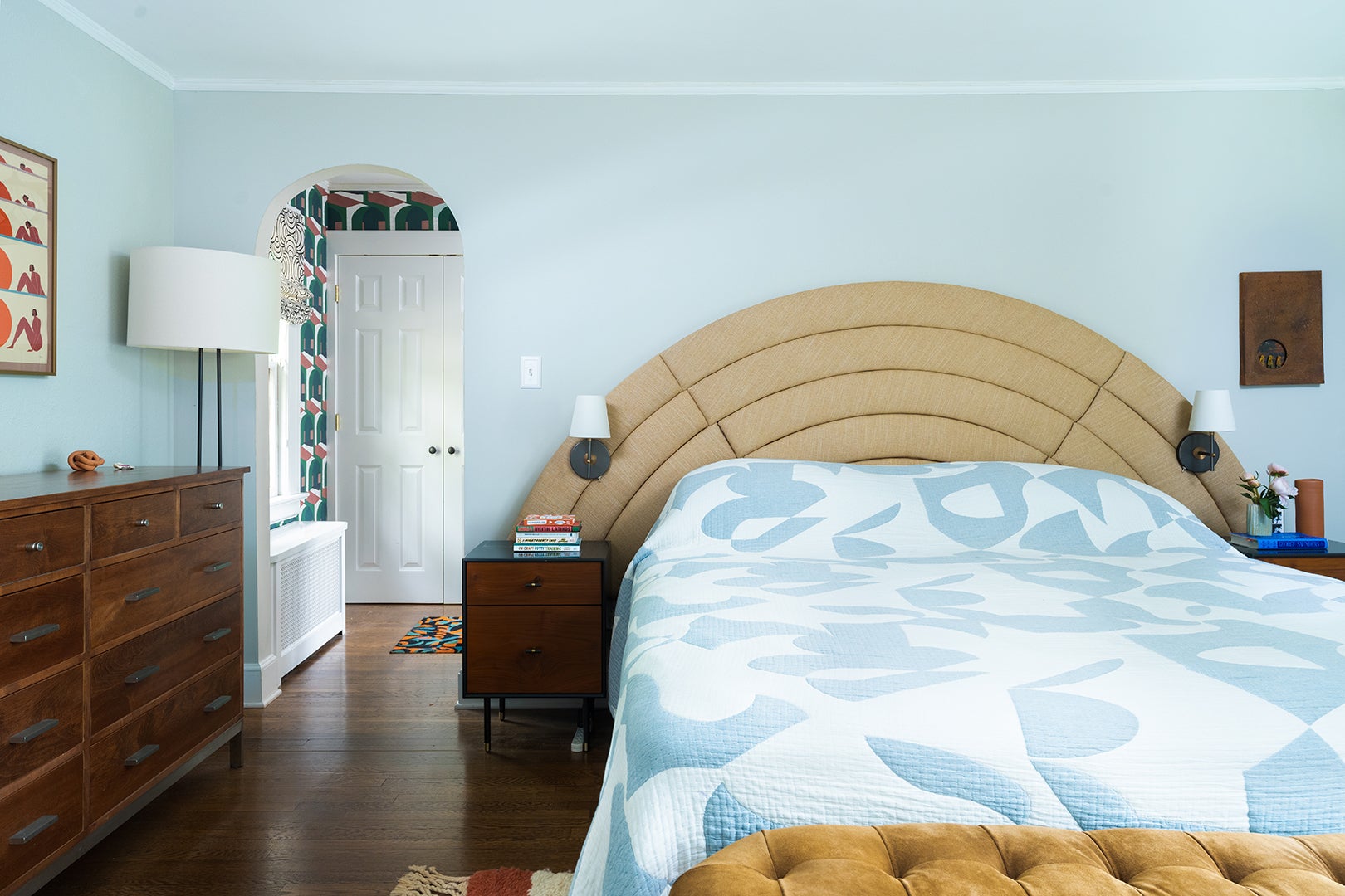 pale blue bedroom with arched headboard