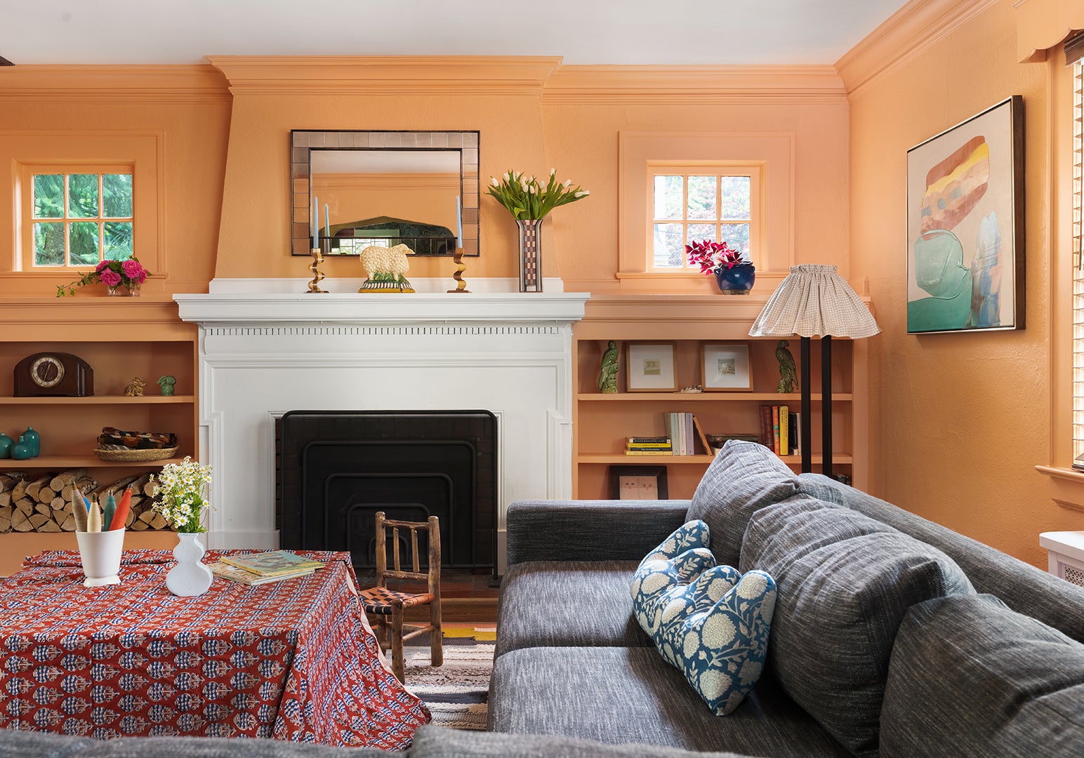 peach living room with built-in fireplace shelves