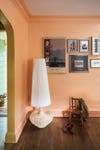 sculptural floor lamp in corner of peach living room