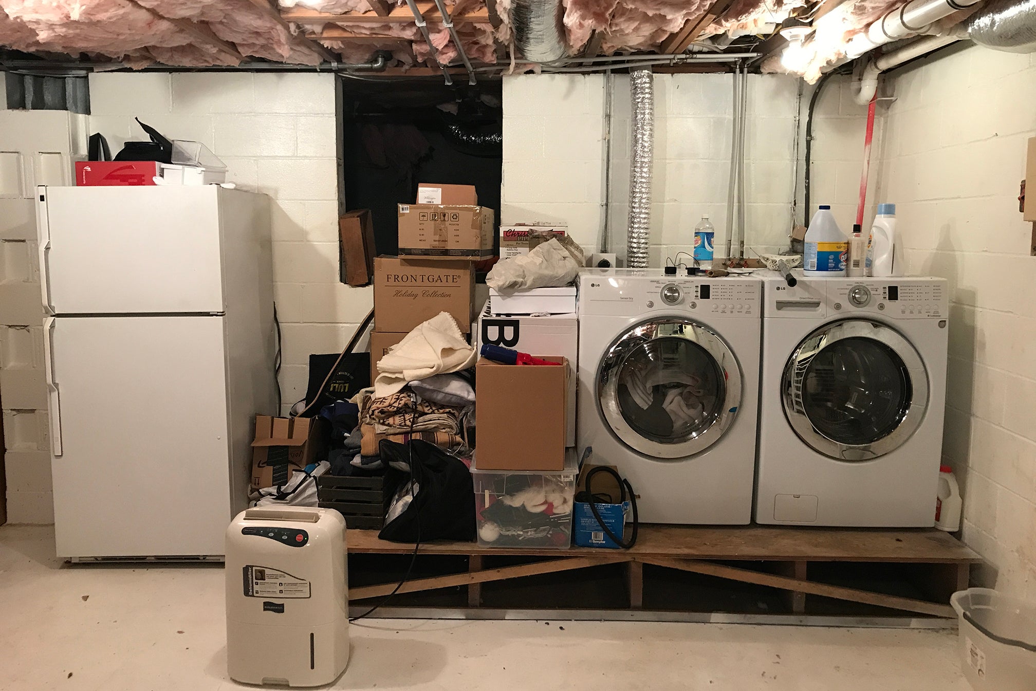 old basement with laundry machines on platform
