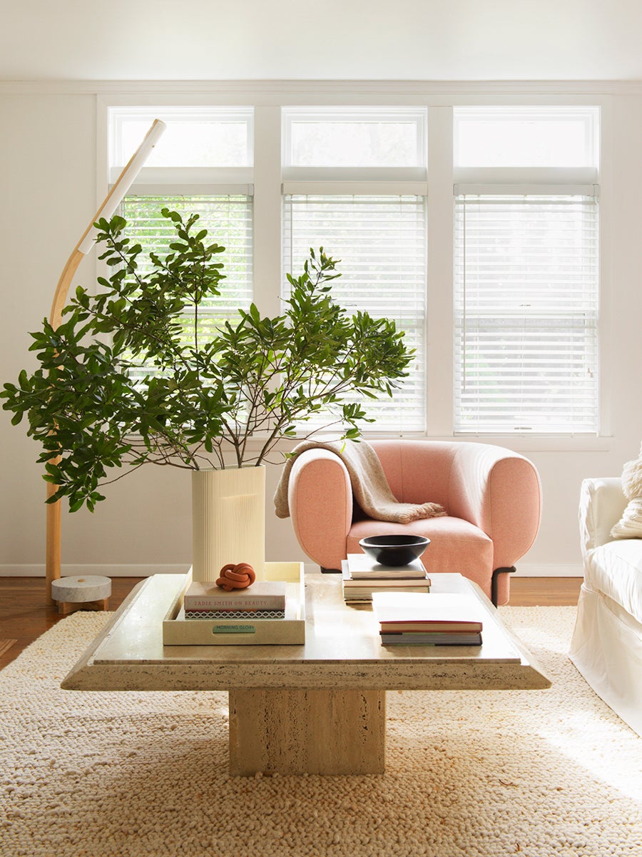 living room with pink chair and windows