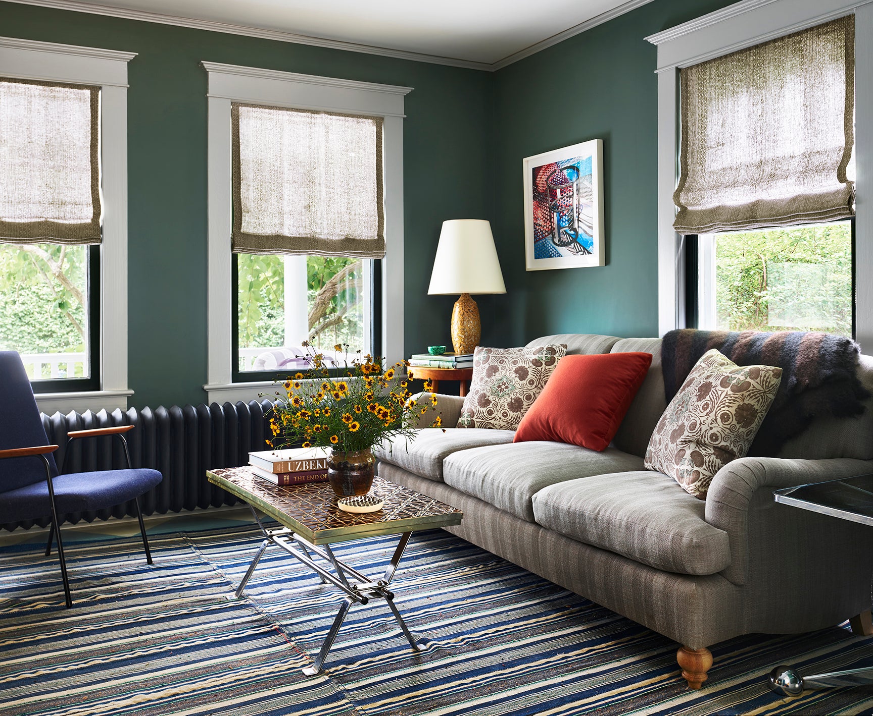 green living room with striped sofa and rug