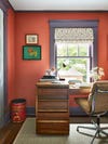 rust office with purple wood trim and mid century desk