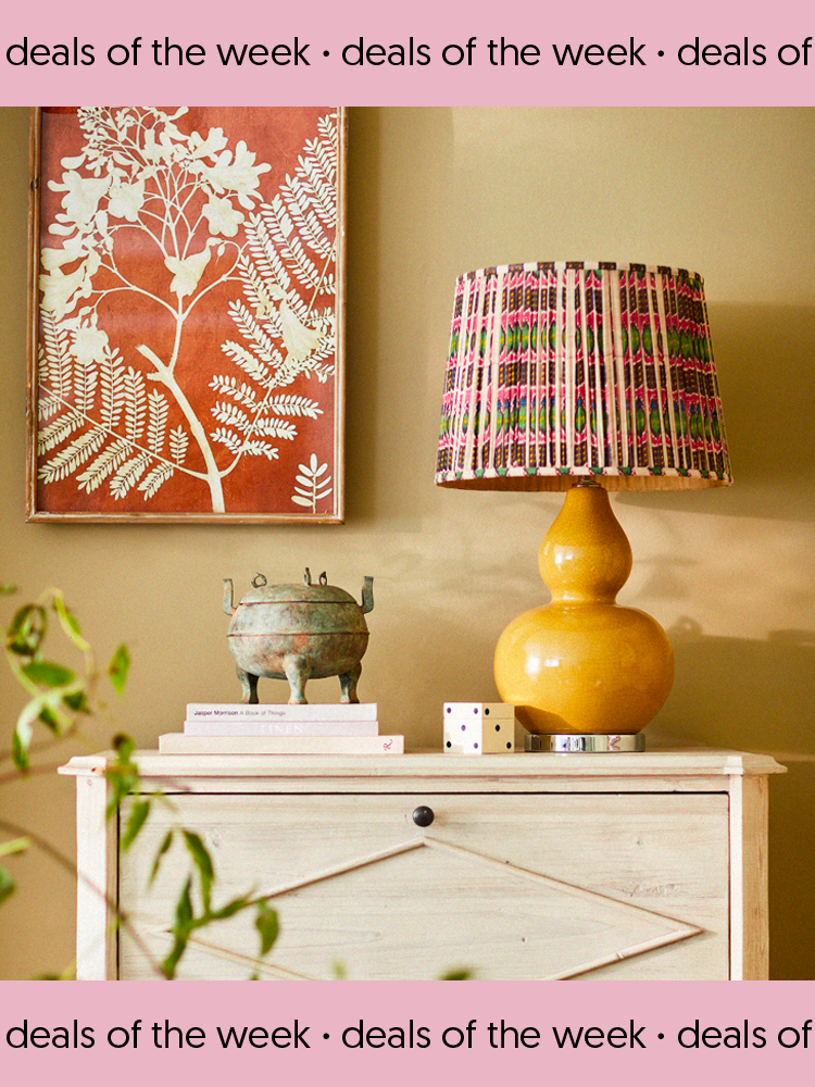 OKA yellow table lamp atop white-wood dresser.