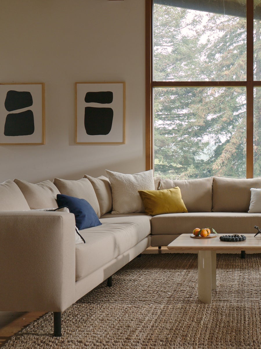 Large living room with sectional couch and jute rug with the city coffee table in bone white