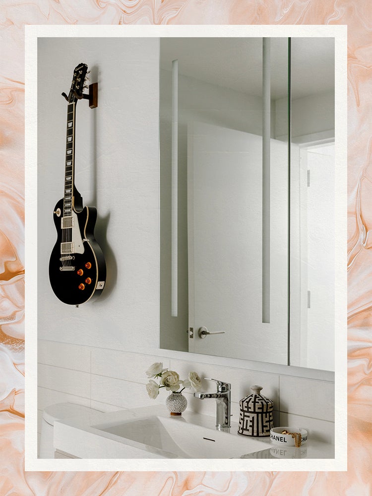 robern lighted bathroom vanity mirror next to wall mounted guitar