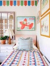pattern-on-pattern twin bed with Babar print above