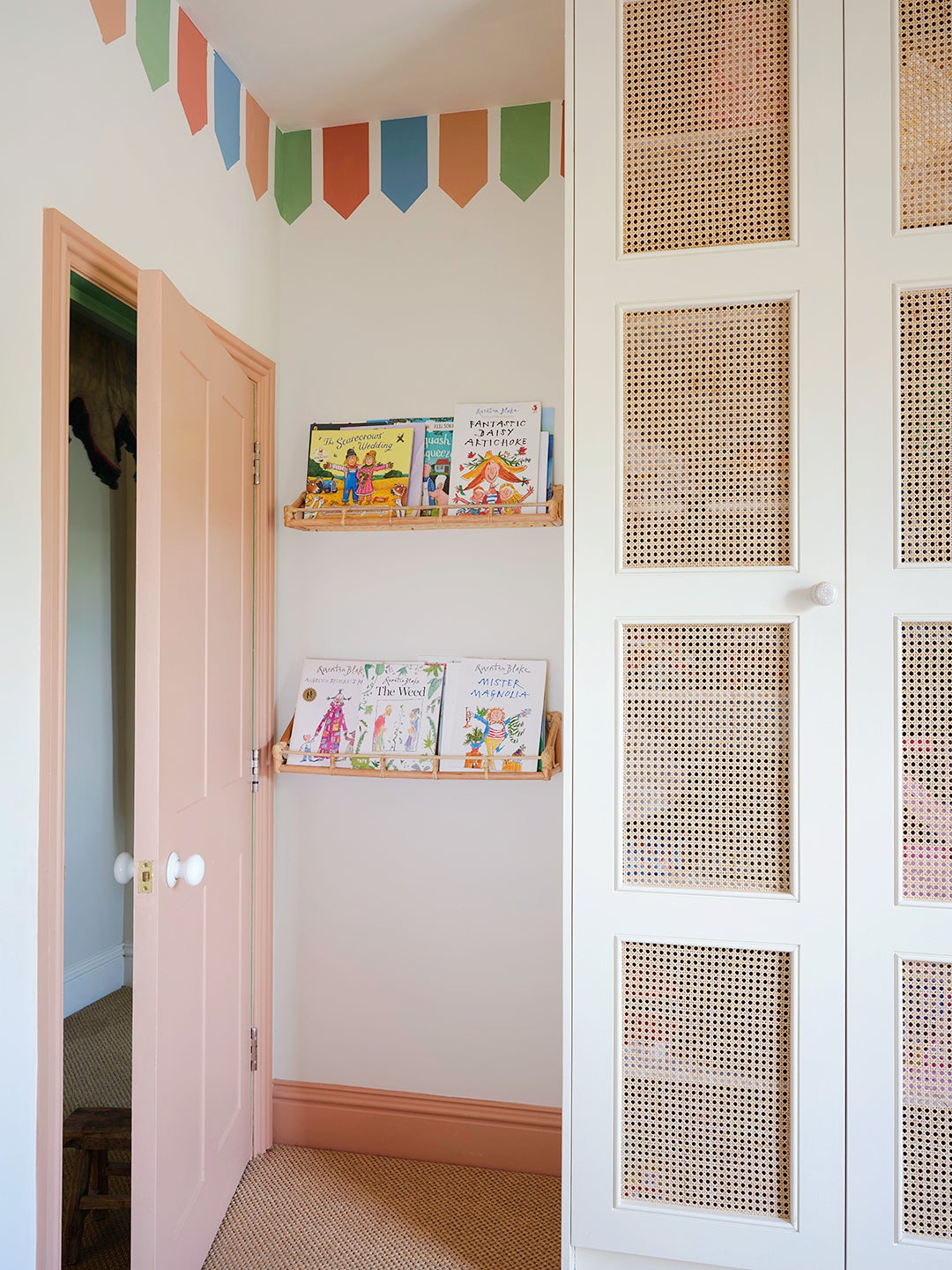 cane-paneled wardrobe in kids' room