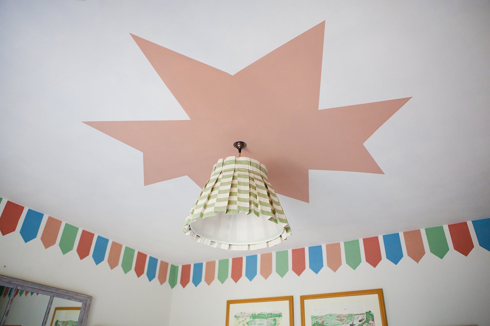 pink star painted around ceiling light