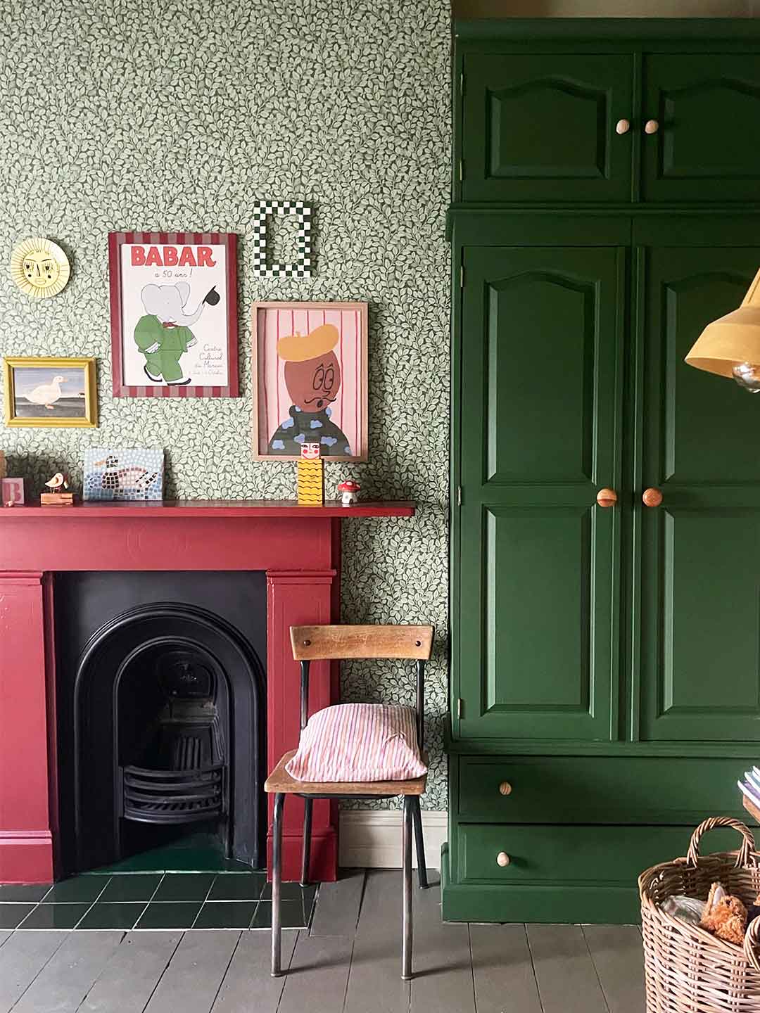 red mantel next to hunter green cabinets