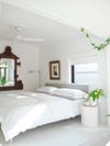 white bedroom with low ceilings