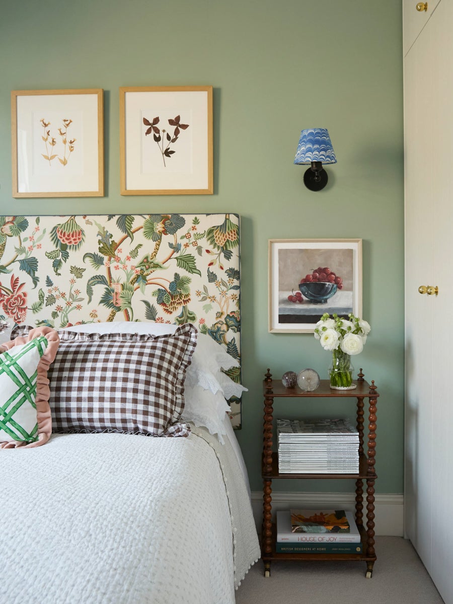green bedroom with floral headboard