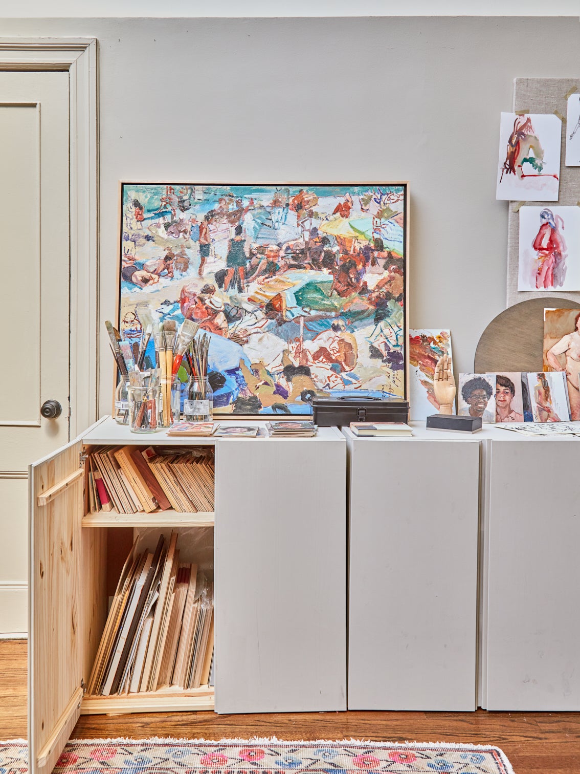 open cabinet filled with art canvases