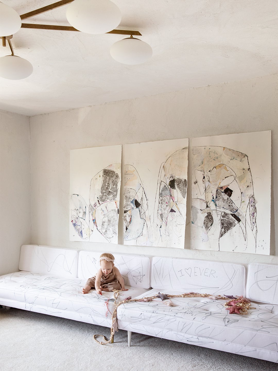 baby drawing on white sofa