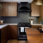 Kitchen with dark walls and wood cabinets