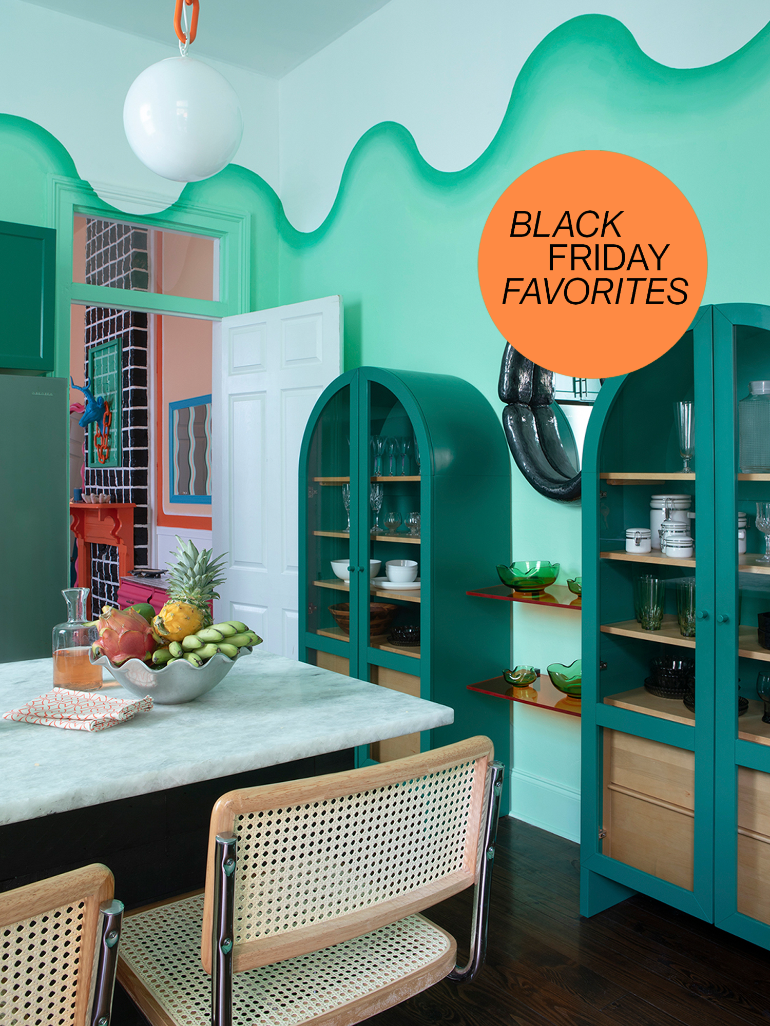 two green storage cabinets connected by open wood shelves in kitschy kitchen and dining room