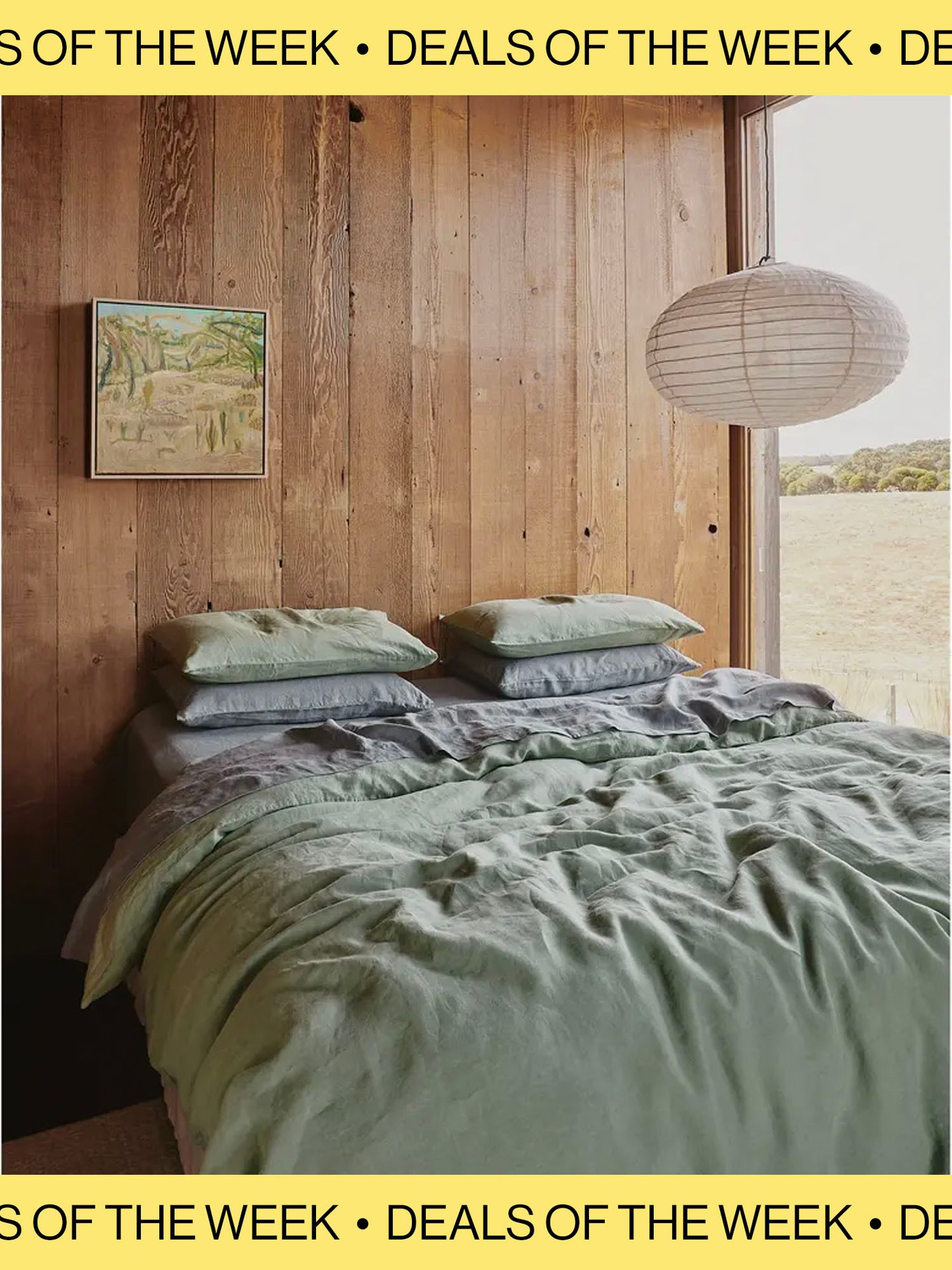 Messy bed with wood panel wall and paper pendant light hanging next to bed for Nordstrom Deals