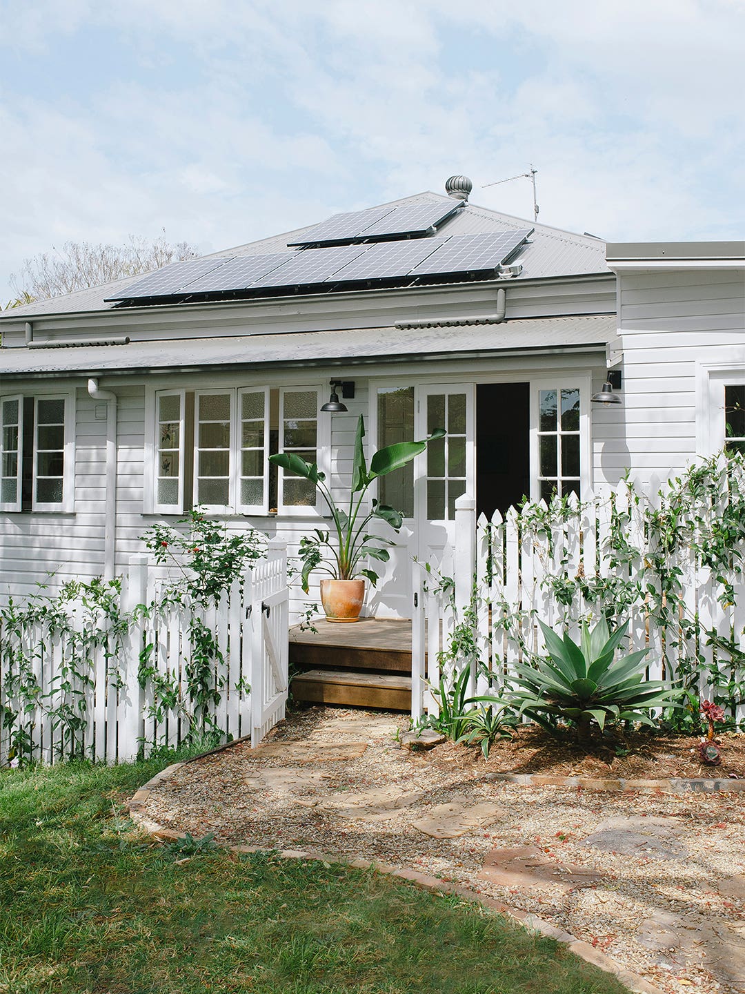 white home with solar panels on roof