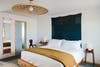 Motel bedroom with clean crisp bedding