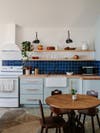 Kitchen with blue cabinets and blue tile