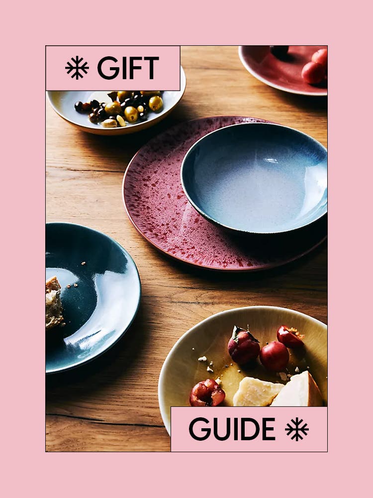 Gigt Guide grid with colorful, glazed bowls and plates on wood table