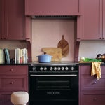 oxblood red kitchen cabinets and black range