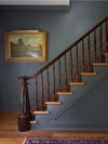 dark blue stairs with wood banister