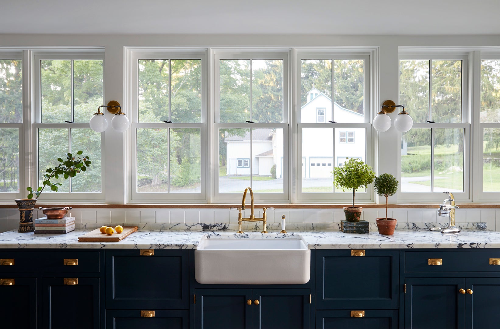 wall of windows with navy cabinets underneath