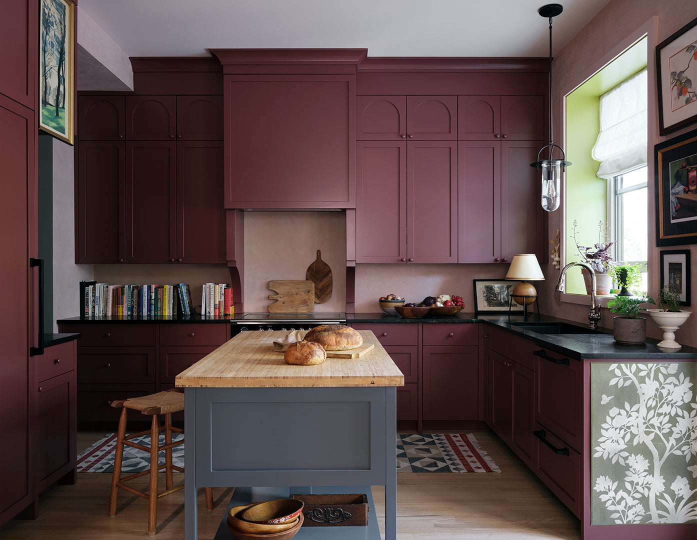 oxblood red kitchen with gray work table
