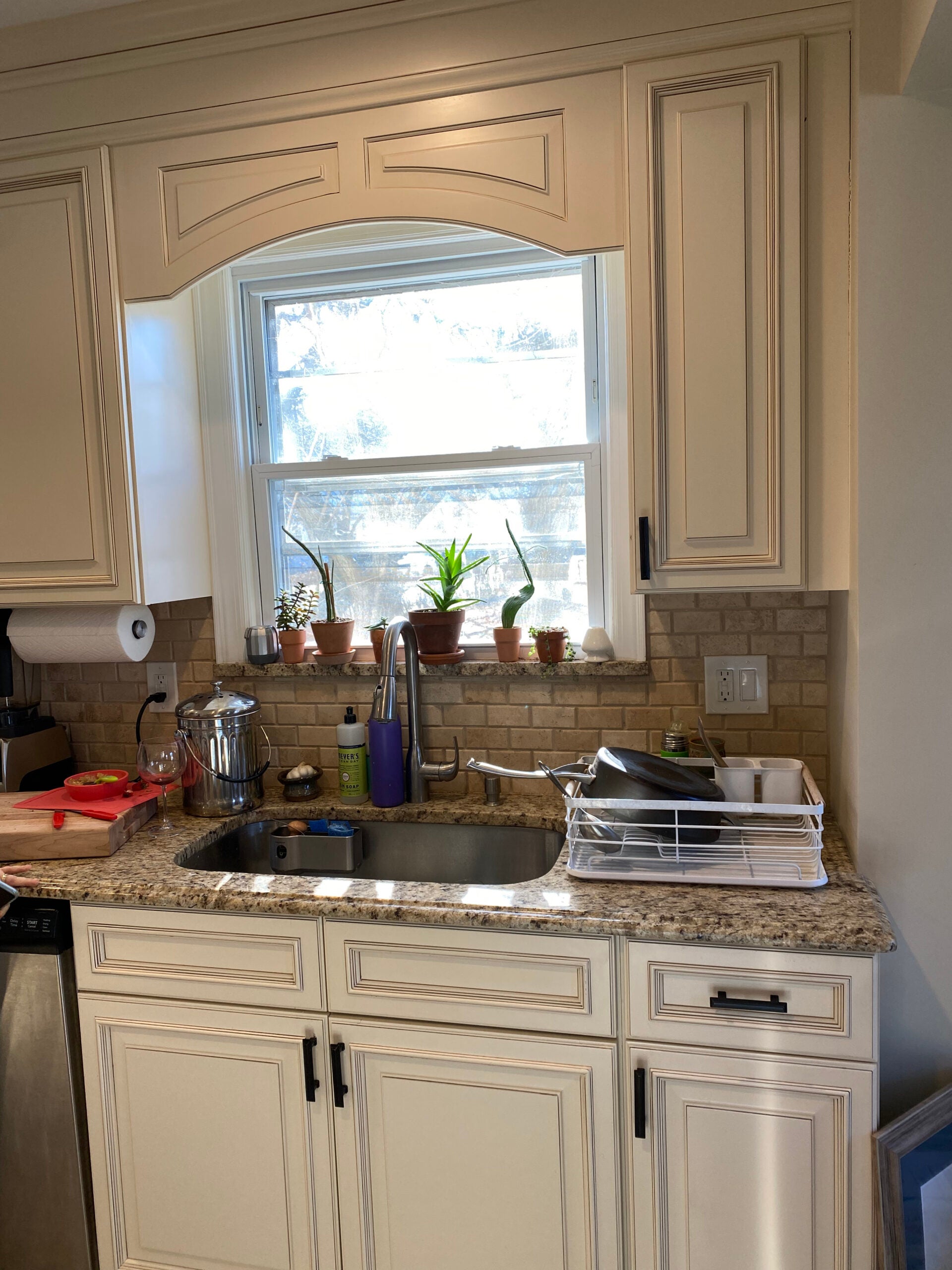 white kitchen with beige granite countertops