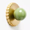 green ball with gold disc cabinet knob