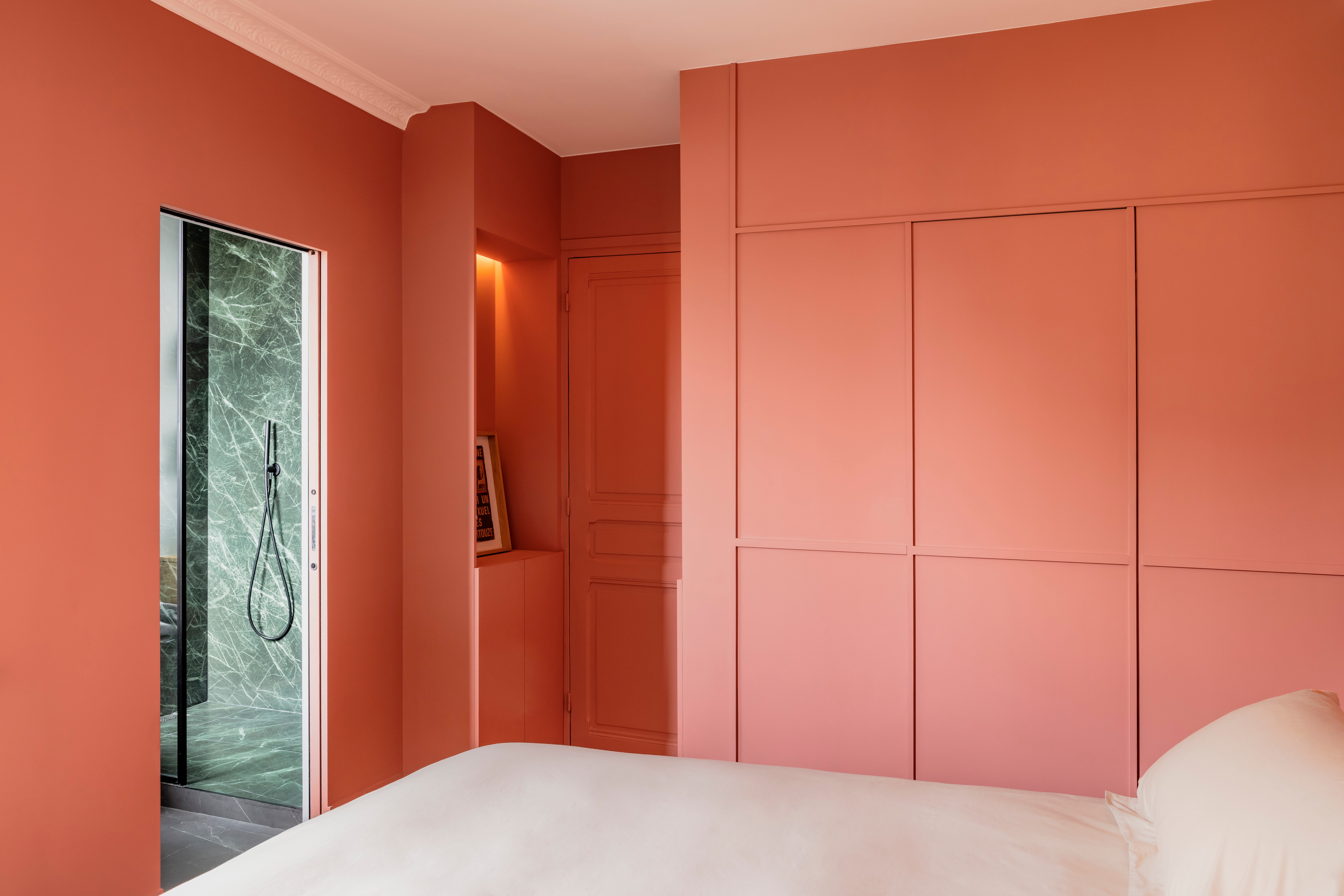 bedroom with pink closet doors