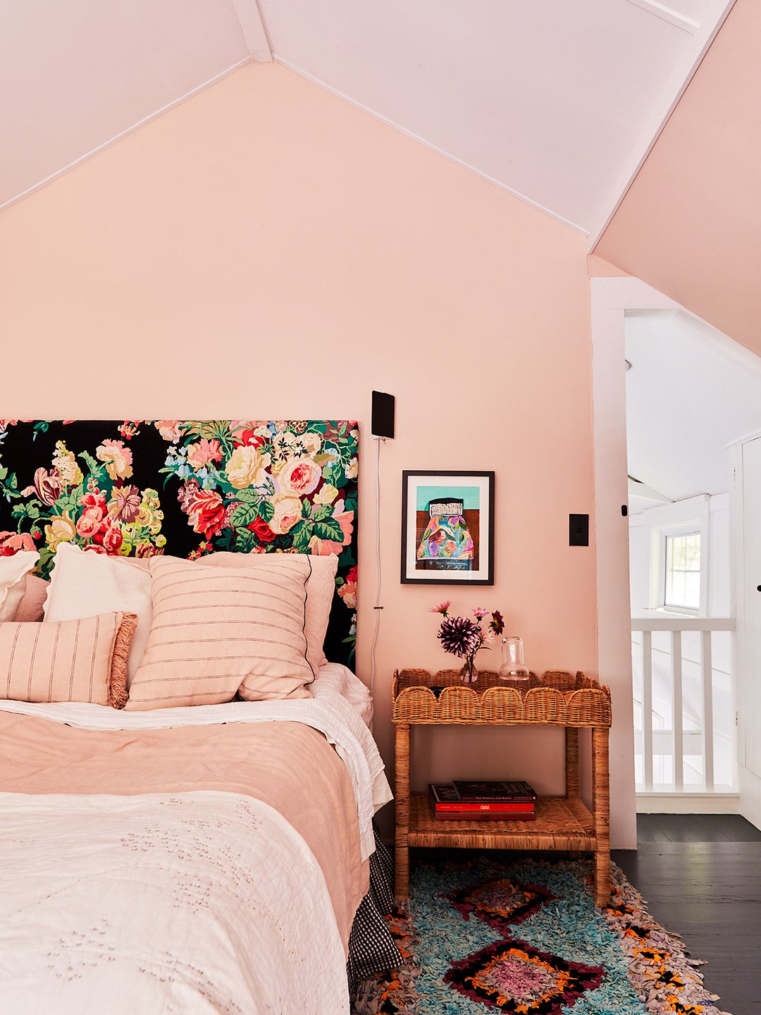 pink bedroom with dark floral headboard