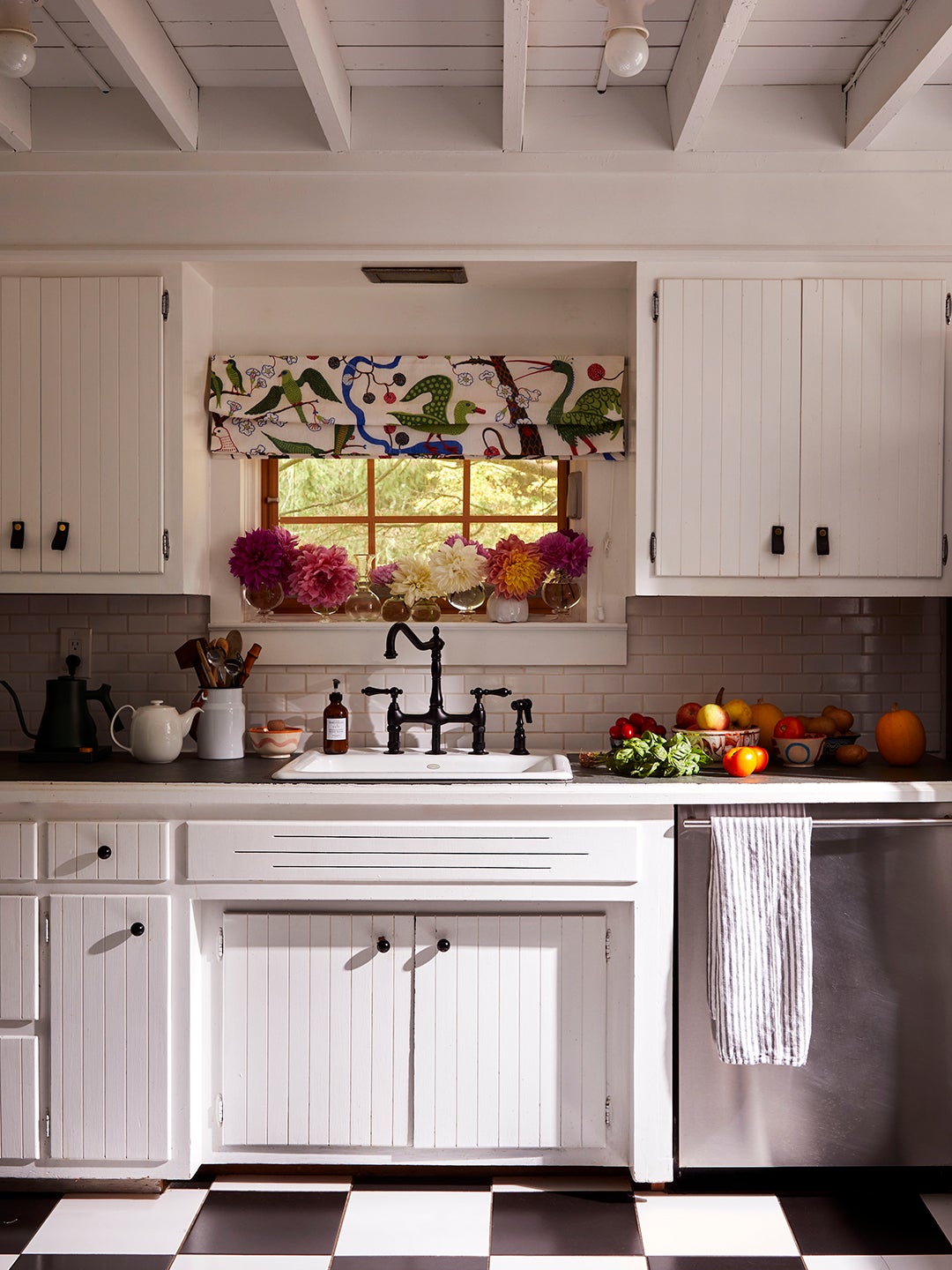 white kitchen with colorful patterned roman window shadow