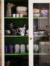 dishes on bright green shelves