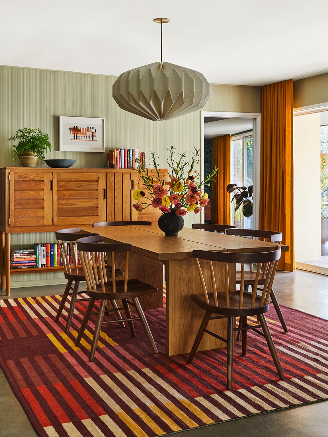 wood dining table on striped rug
