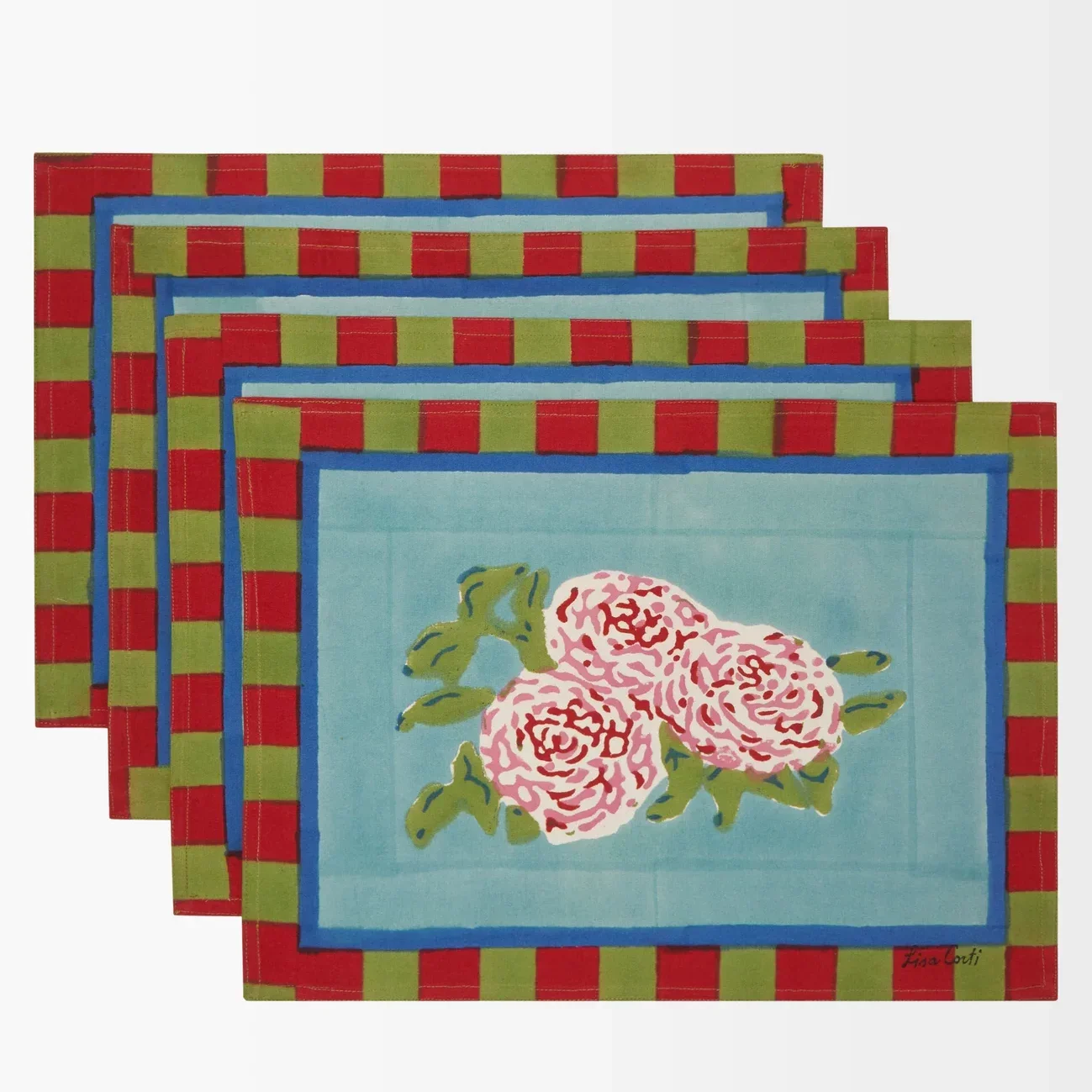 Four floral placemats with red and green striped borders diagonally arranged on a white surface.