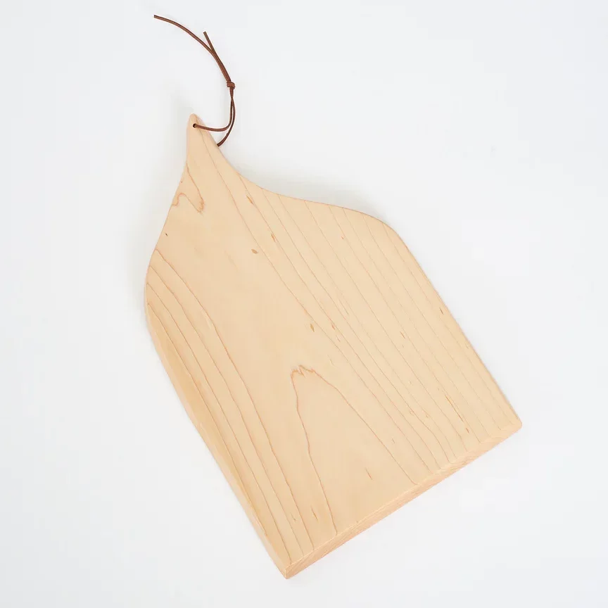 Maple wood cutting board on a white background.