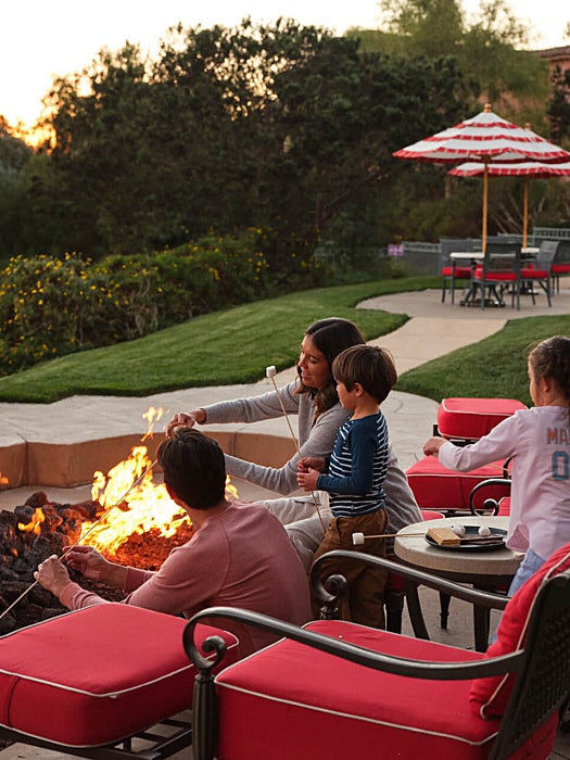 family with kids at firepit