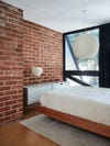 exposed brick wall with minimalist dresser