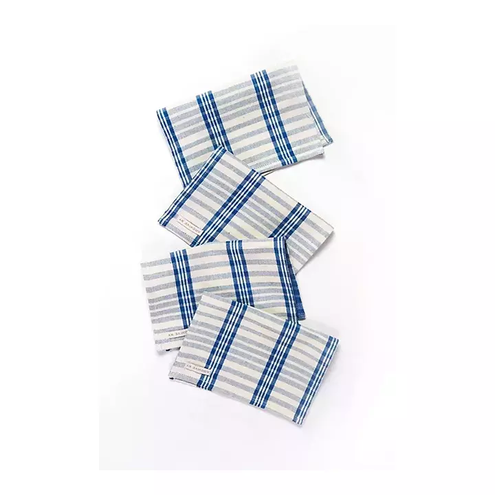 Four dark and light blue striped napkins against a white background.