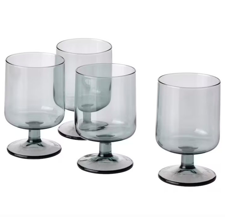 Four gray glass IKEA Ombonad goblets against a white background.