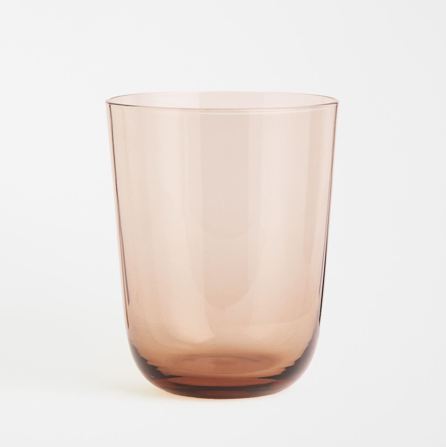 Beige beverage glass against a white background.