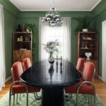 green dining room with vintage furniture